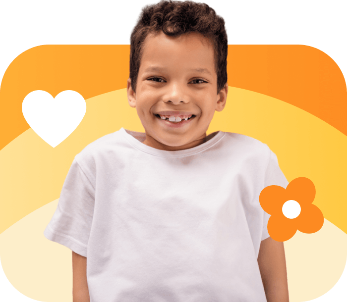 Student smiling to the camers with a flower and a white heart